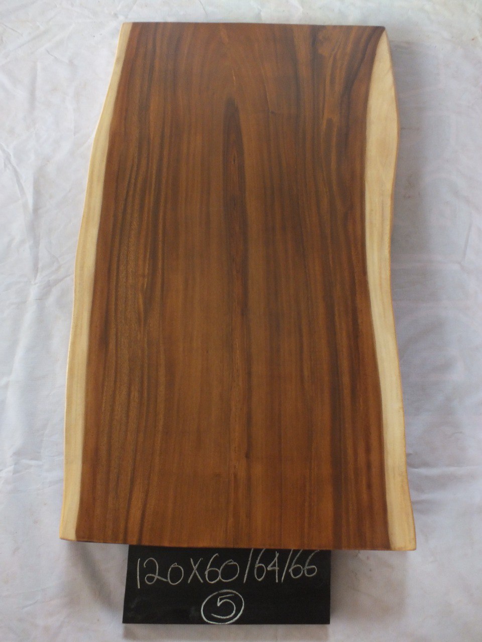 Top view of suar wood slab 0005-606466 with balanced live edge shape and warm brown natural wood grain, solid single-piece countertop.
