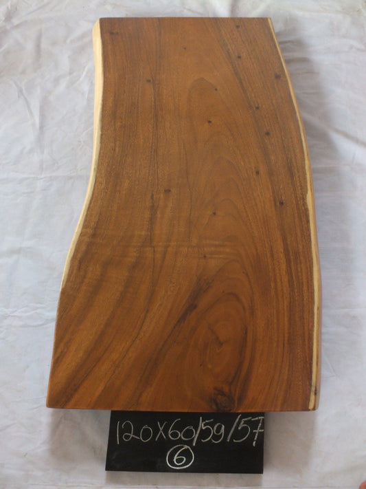 Top view of suar wood slab 0006-605957 with gently narrowing live edge shape and warm brown natural wood grain, solid single-piece countertop.
