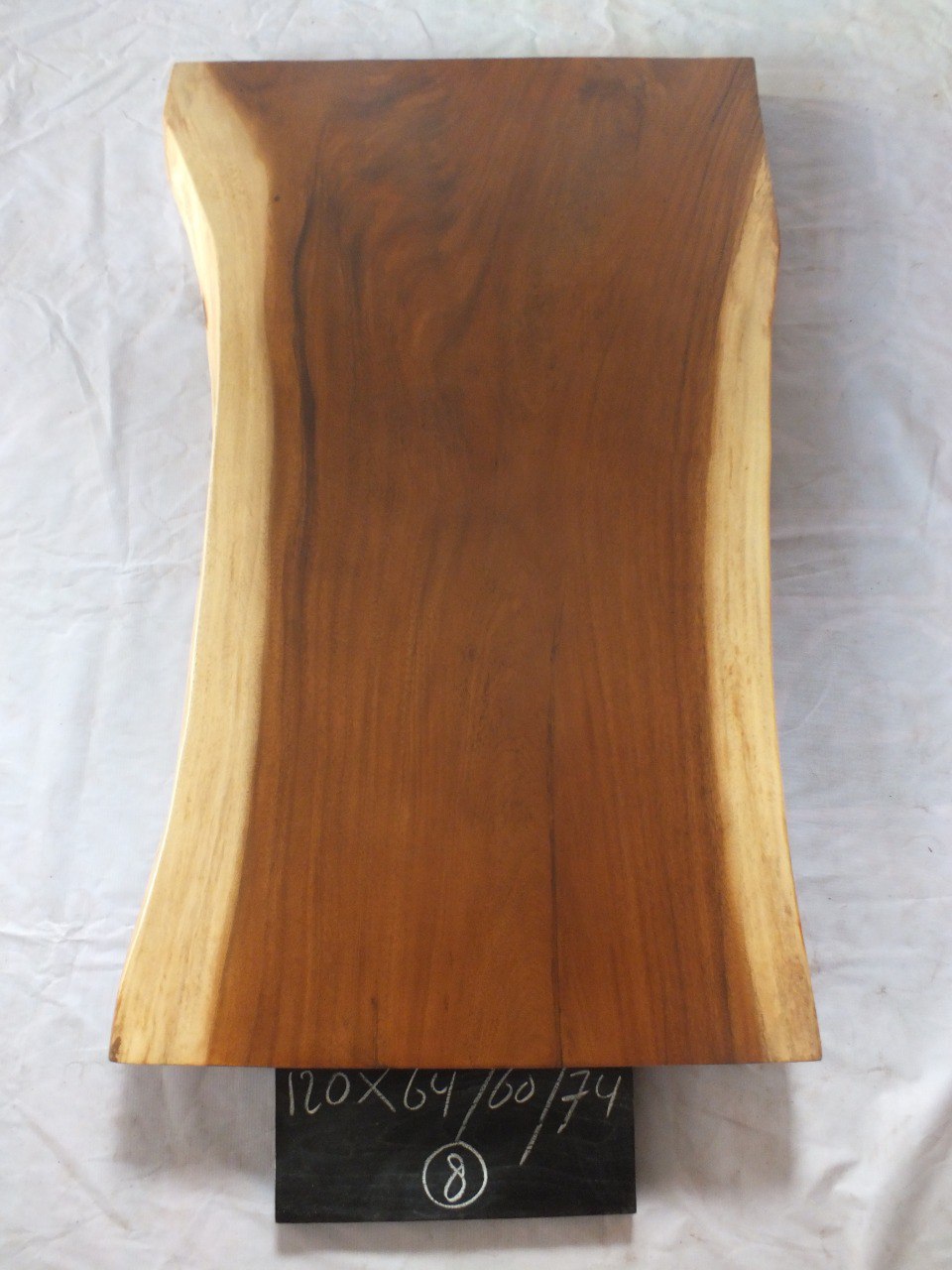 Top view of suar wood slab 0008-646074 with contoured live edges and rich brown natural wood grain, solid single-piece countertop.
