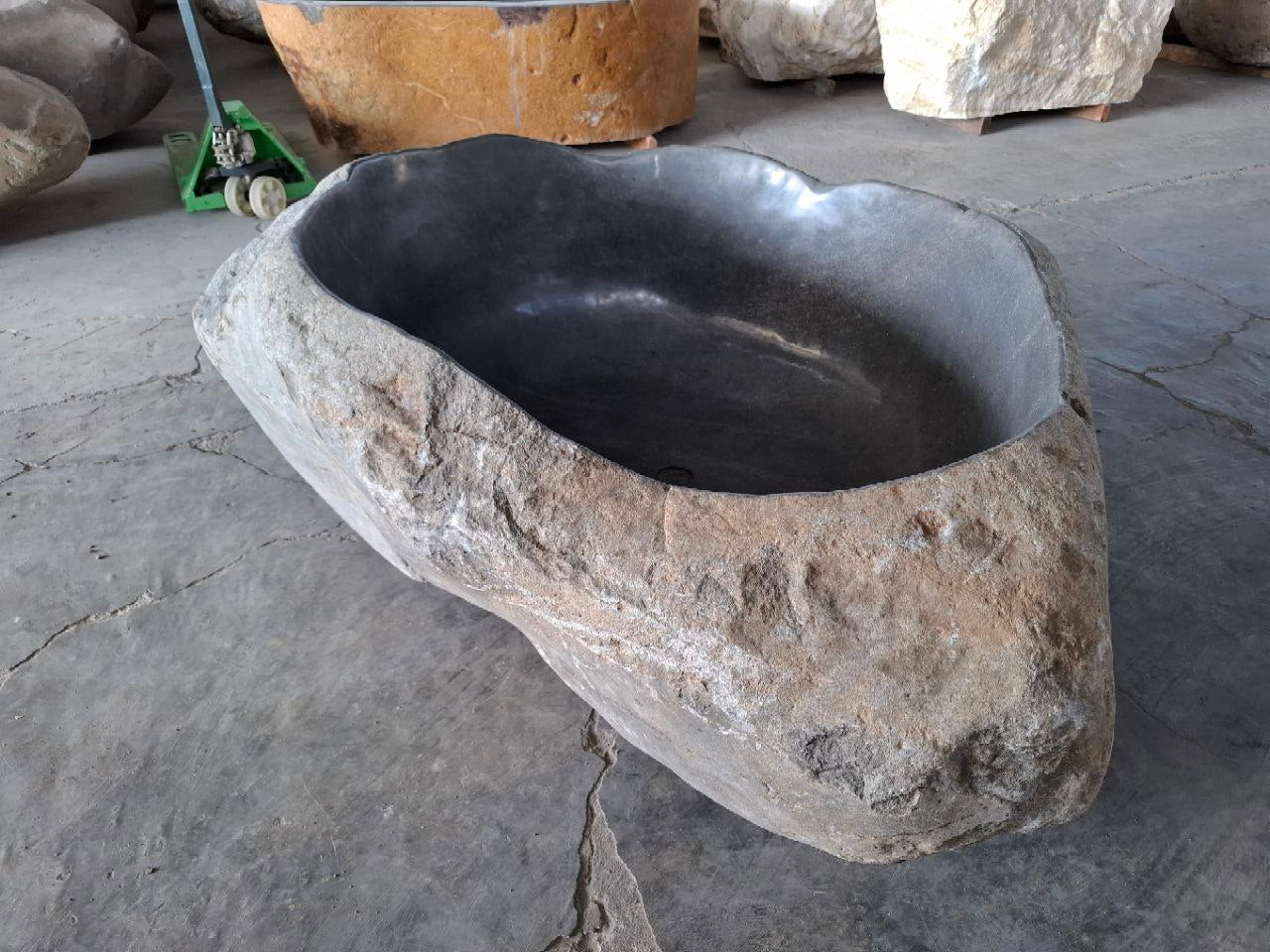 Freestanding bathtub carved from a single river stone
