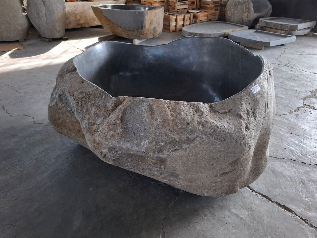 Organic shaped natural stone bathtub on display
