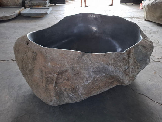 Top view of river stone bathtub with polished interior
