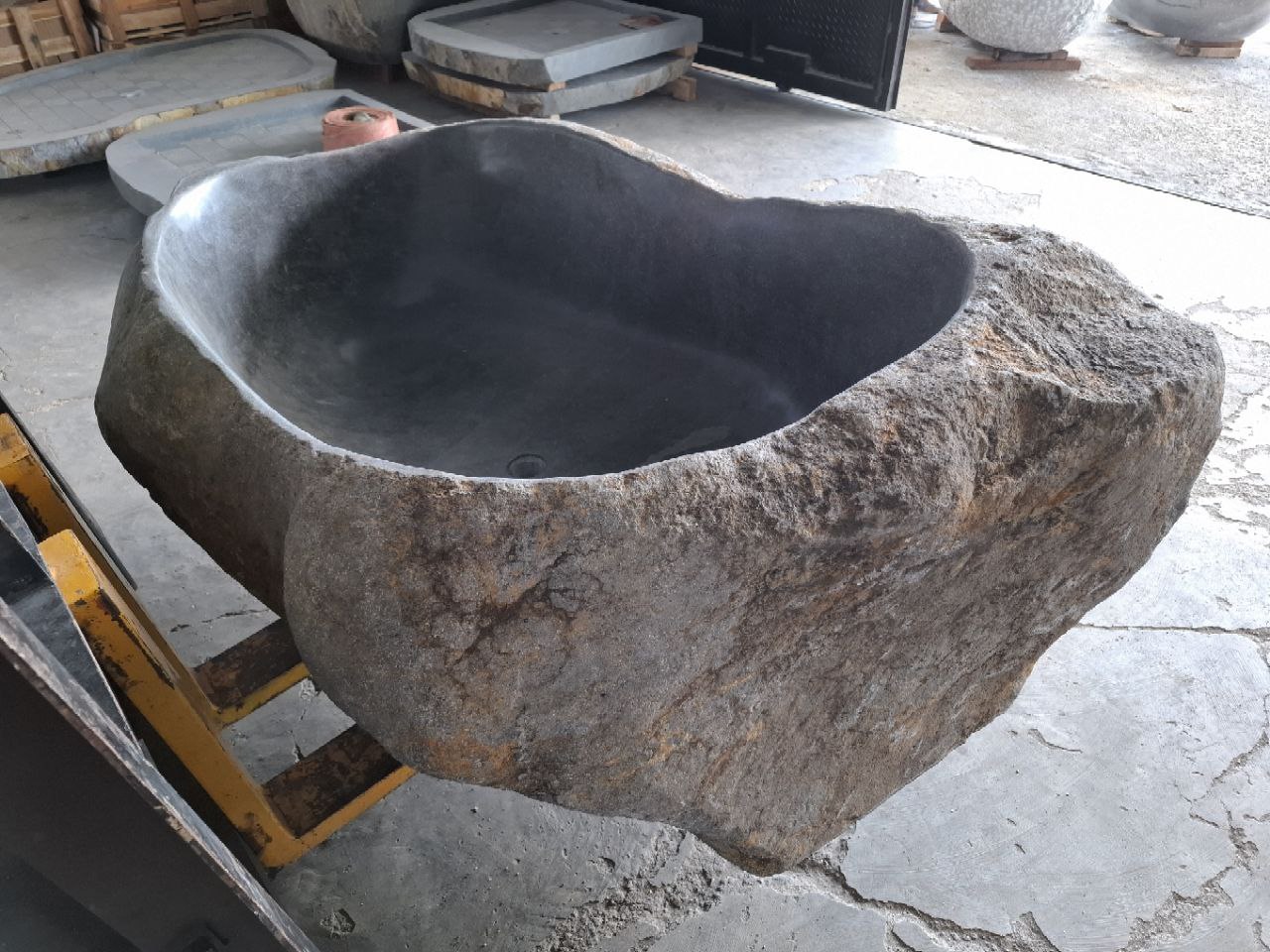 Freestanding bathtub handcrafted from natural river stone
