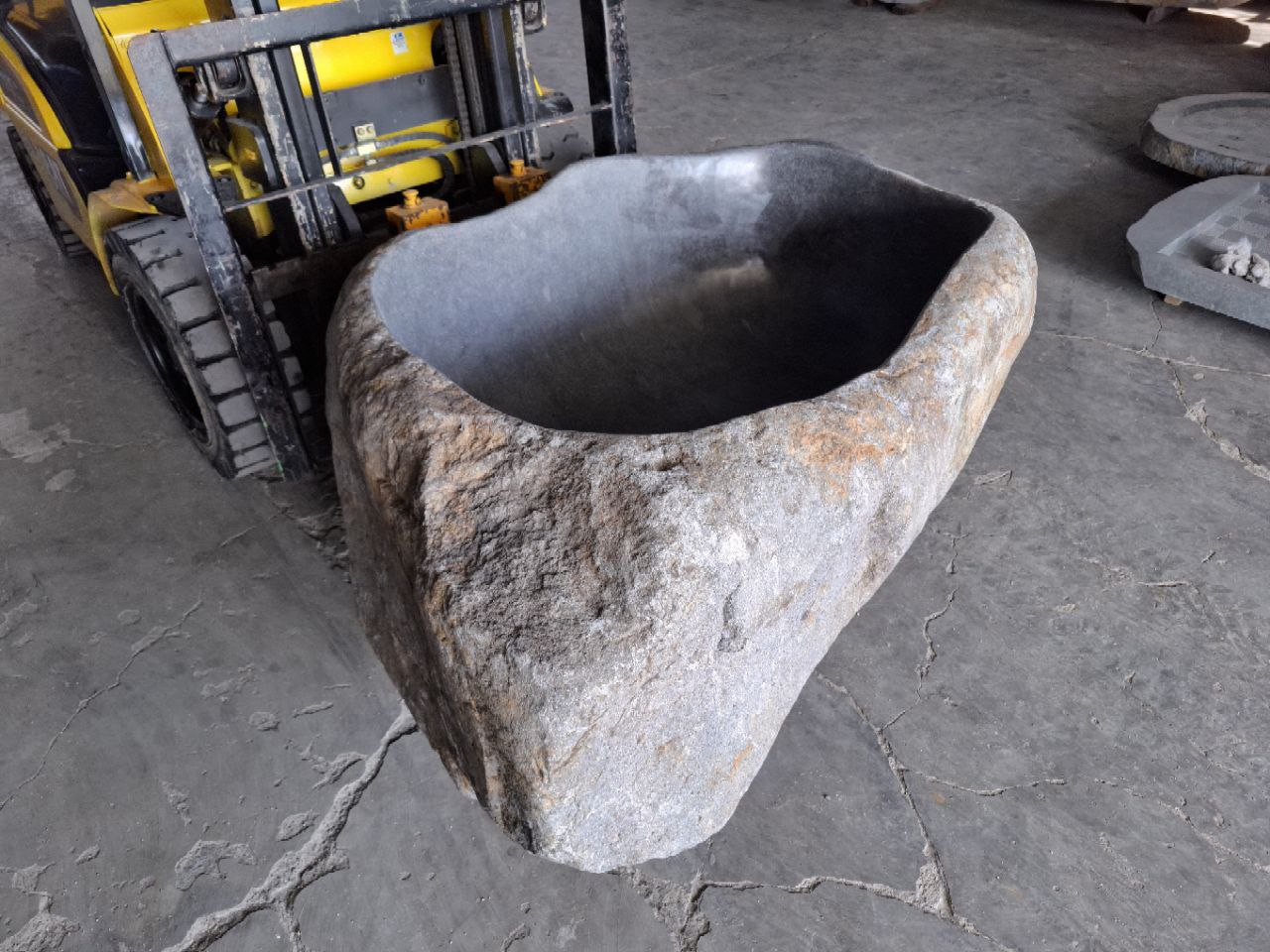 Organic shaped bathtub carved from solid river stone
