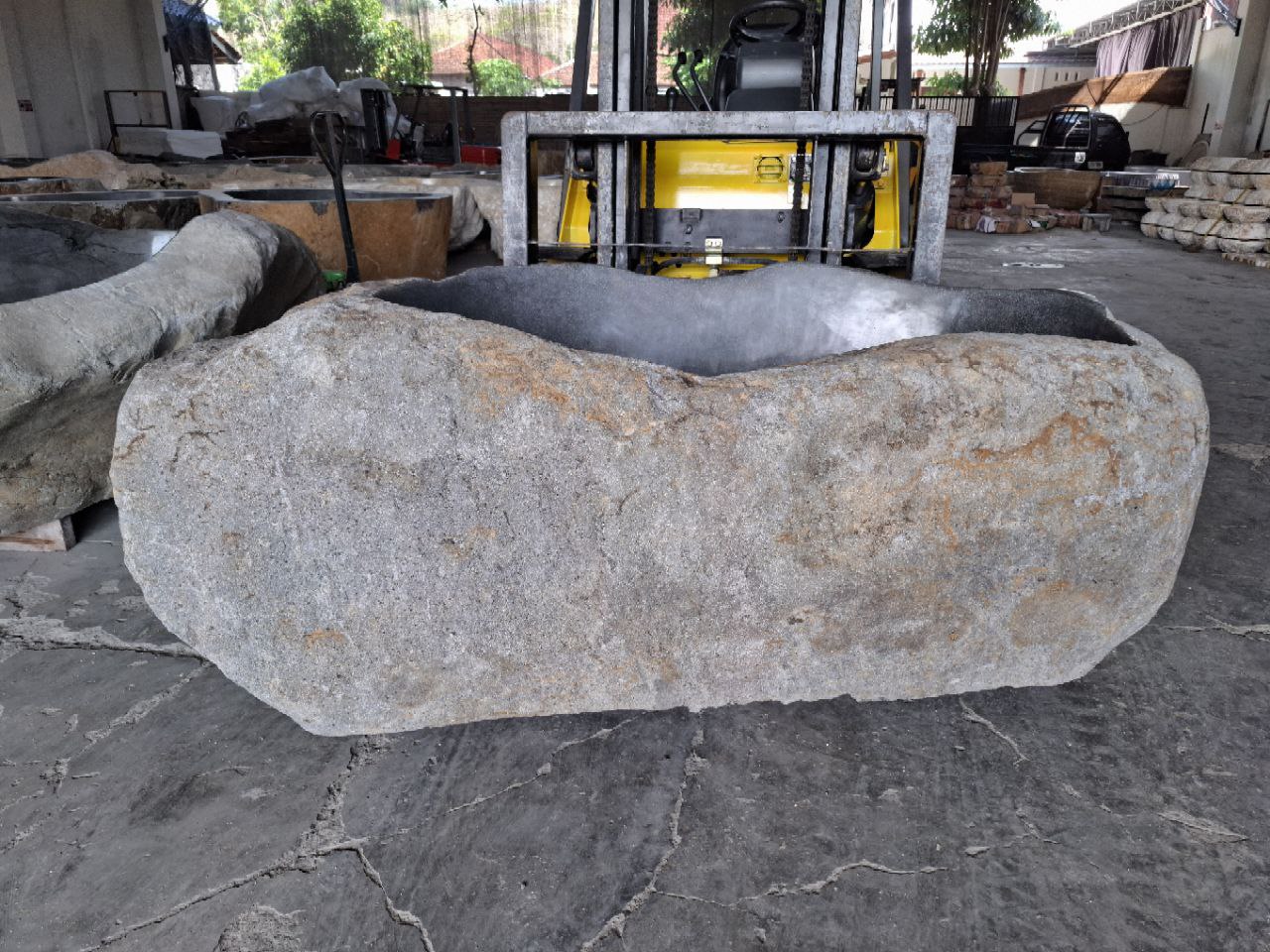 Side angle showing rugged natural stone exterior

