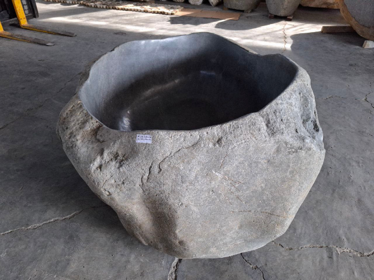 Close-up of polished interior surface of river stone tub

