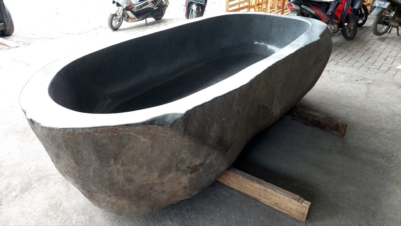 Freestanding extra-large bathtub carved from natural river stone
