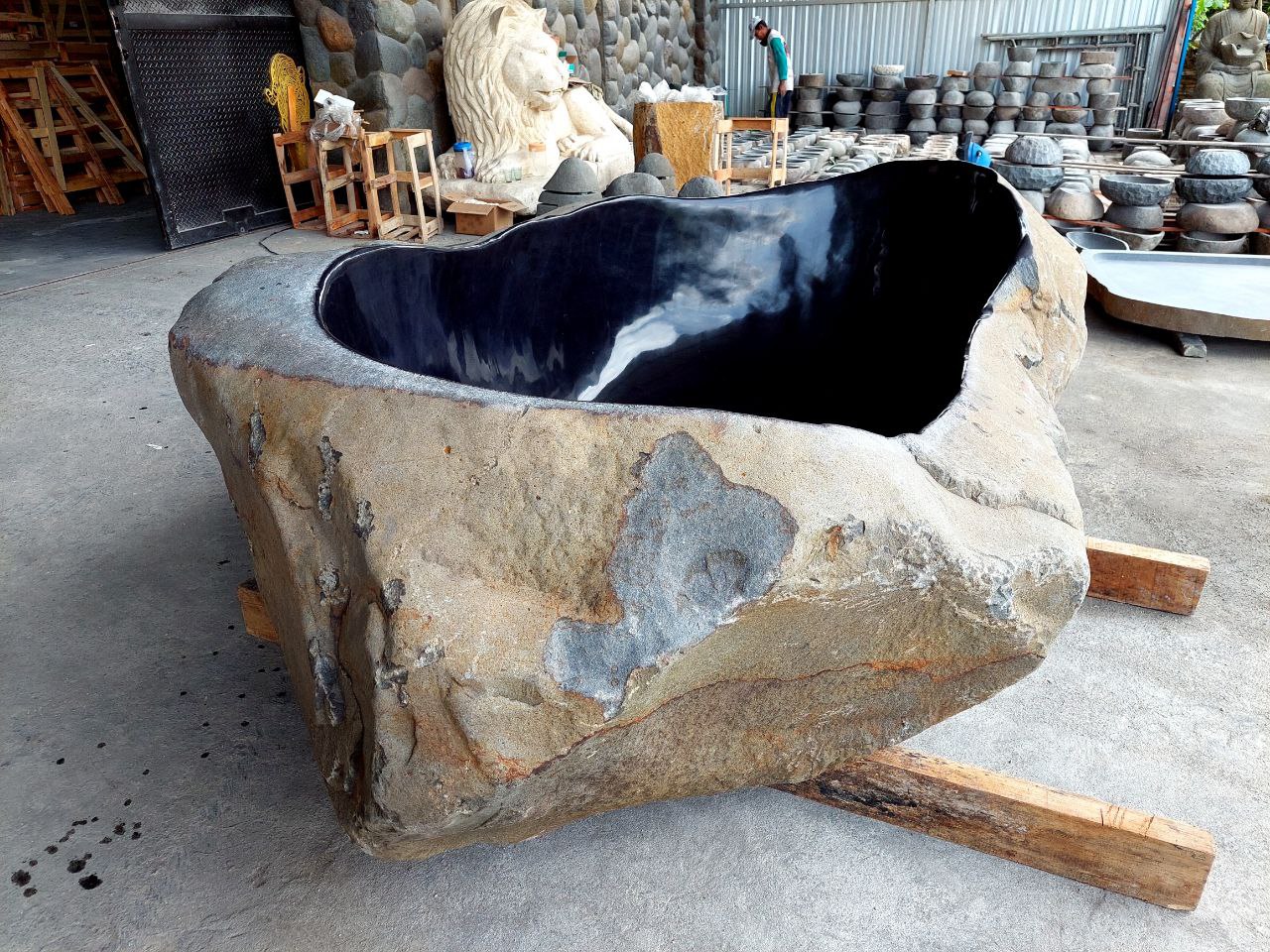 Oversized river stone bathtub – outdoor spa installation
