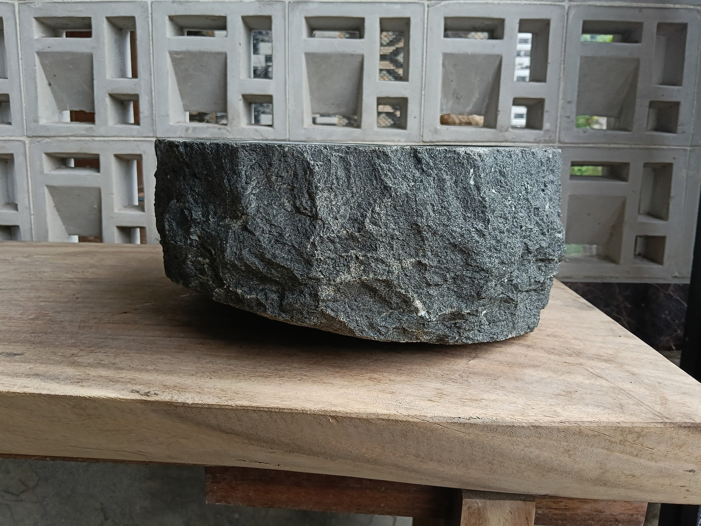 Left side of 60A8-4236 handcrafted dark gray andesite stone basin
