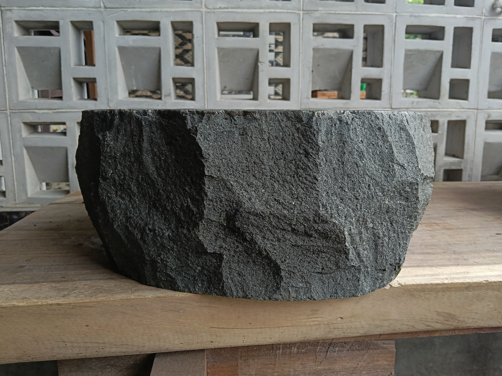 Left side of 6A10-4136 handcrafted dark gray andesite stone basin
