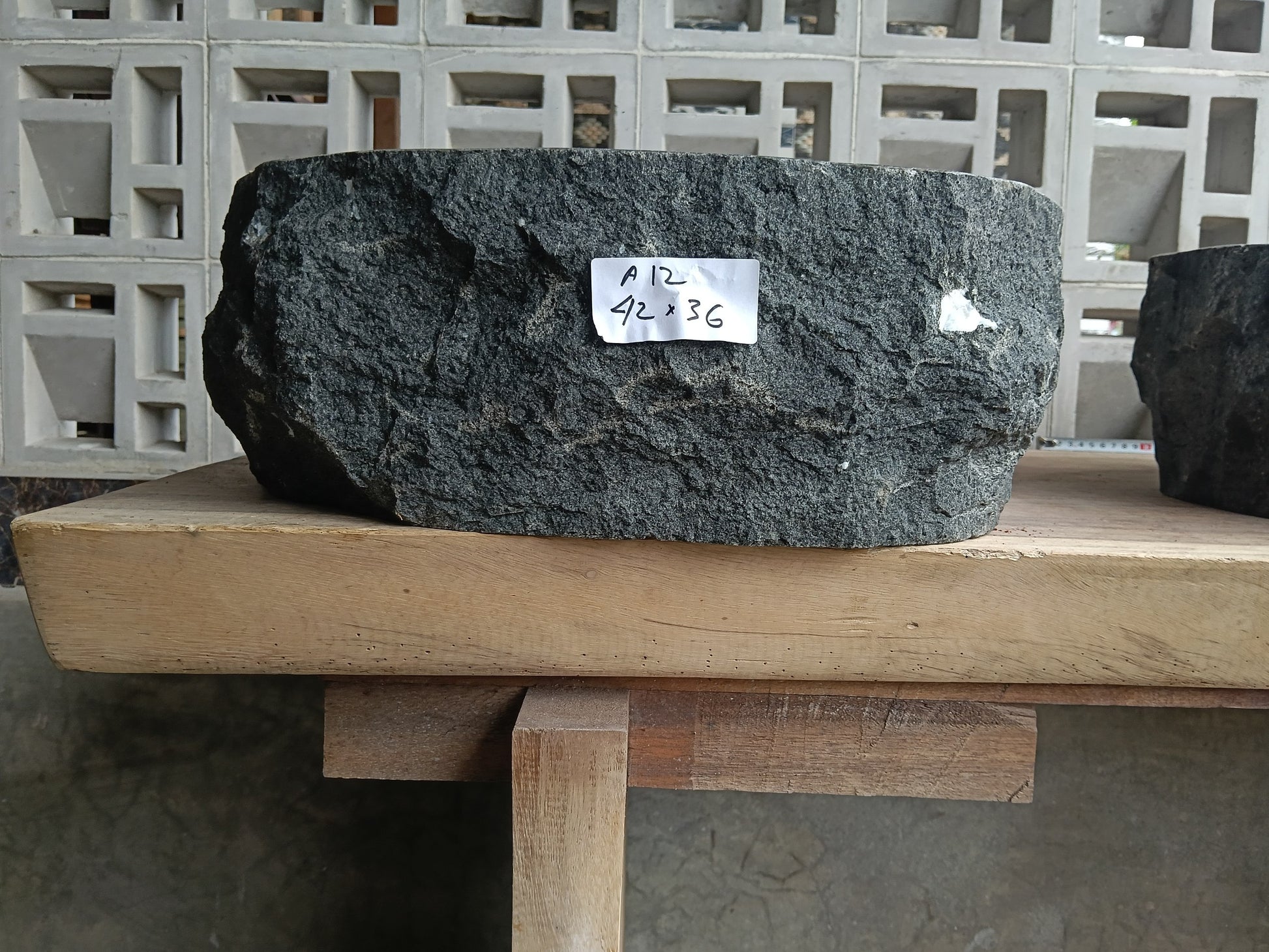 Front view of 6A12-4236 andesite vessel basin — polished oval interior
