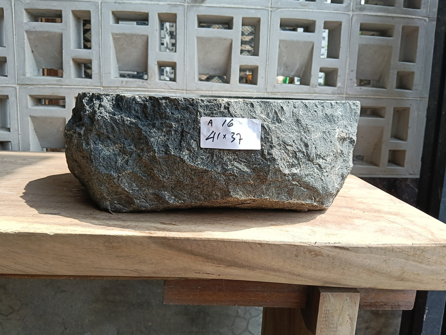 Front view of 6A16-4137 andesite vessel basin — polished oval interior
