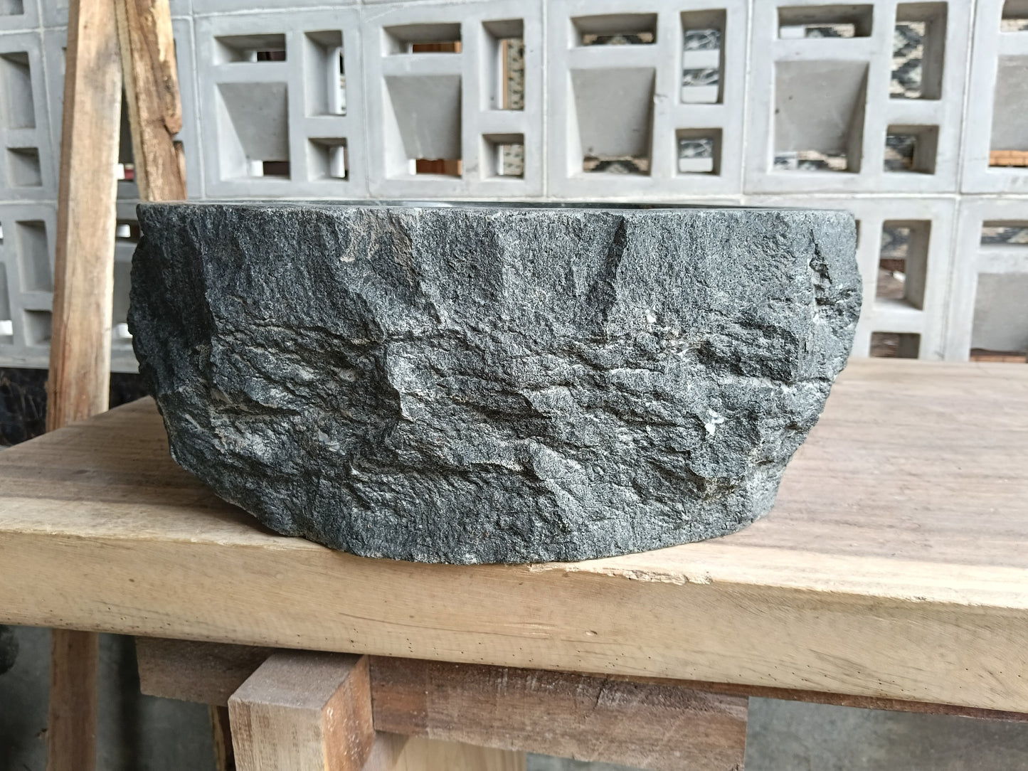 Left side of 60A3-4237 handcrafted dark gray andesite stone basin
