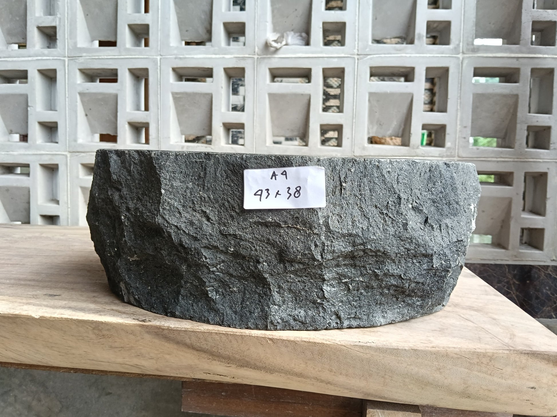Front view of 60A4-4338 andesite stone basin — polished interior and raw edge
