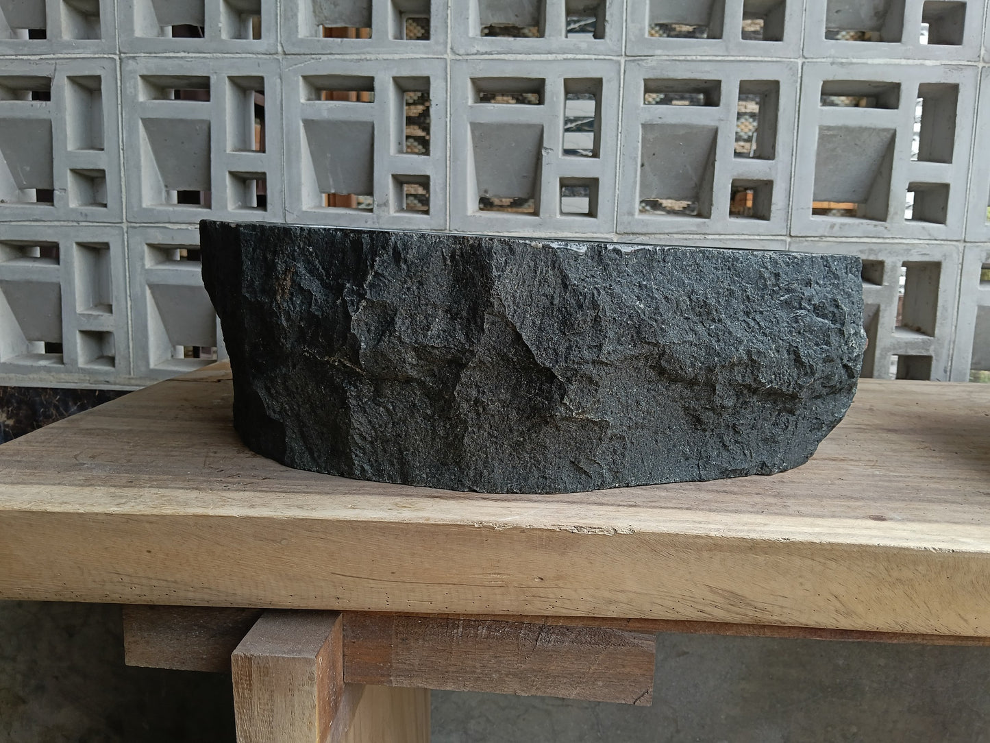 Back view of 6A24-5140 natural andesite basin — textured exterior surface
