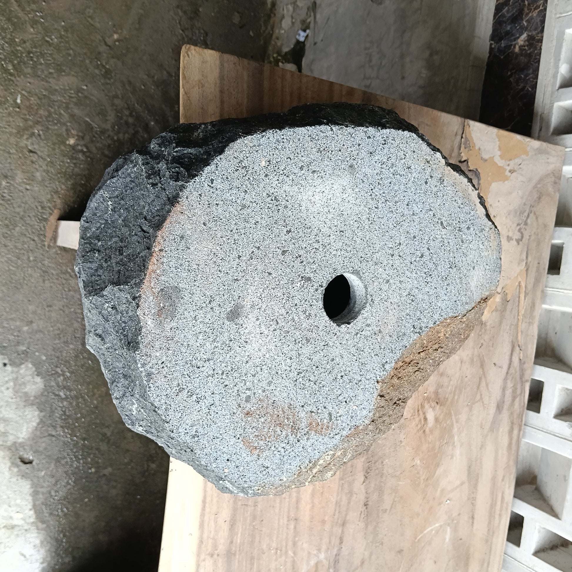 Bottom view of 6A29-4235 solid andesite stone sink — standard drain hole
