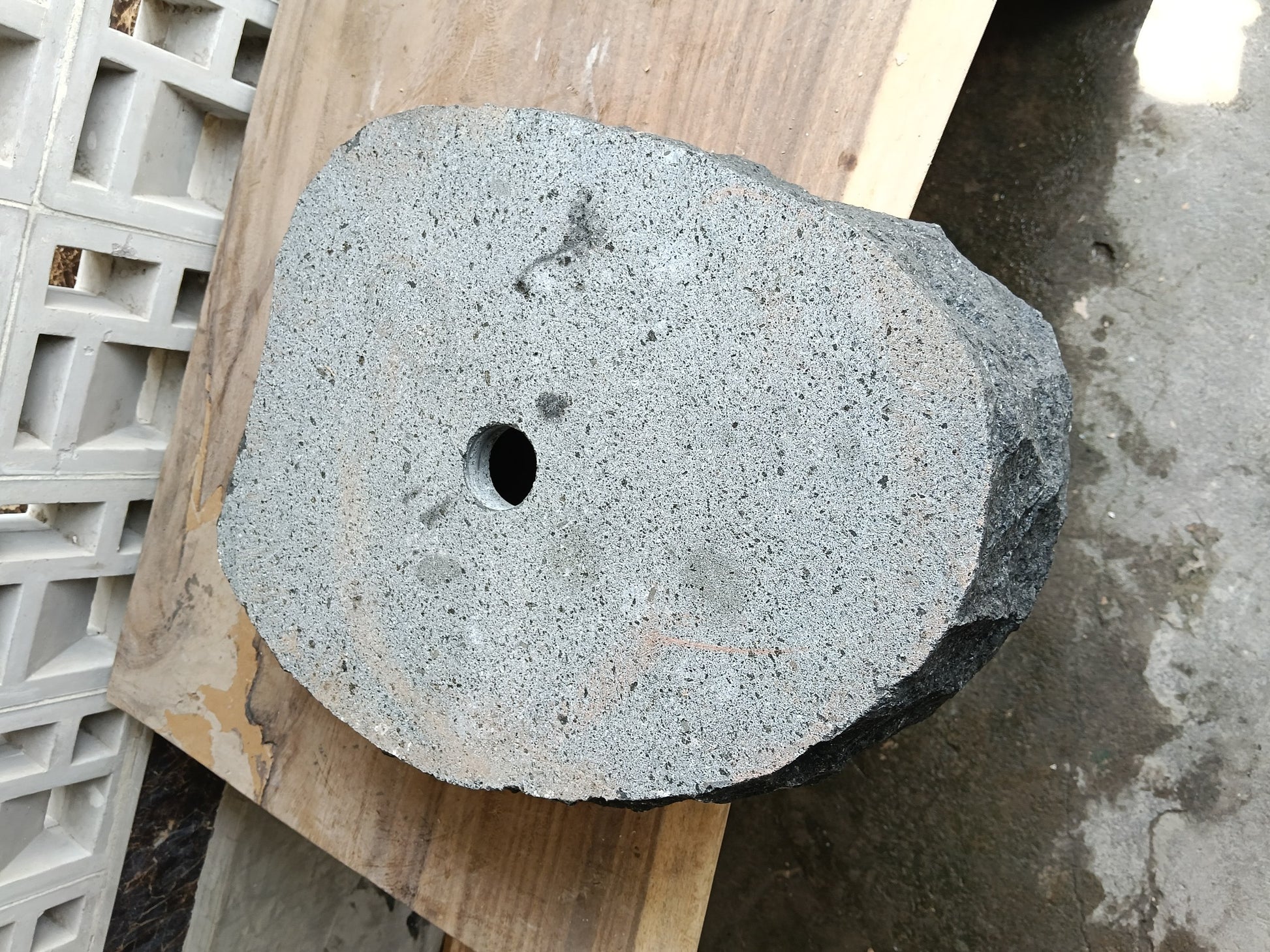 Bottom view of 6A32-5141 solid andesite stone sink — standard drain hole
