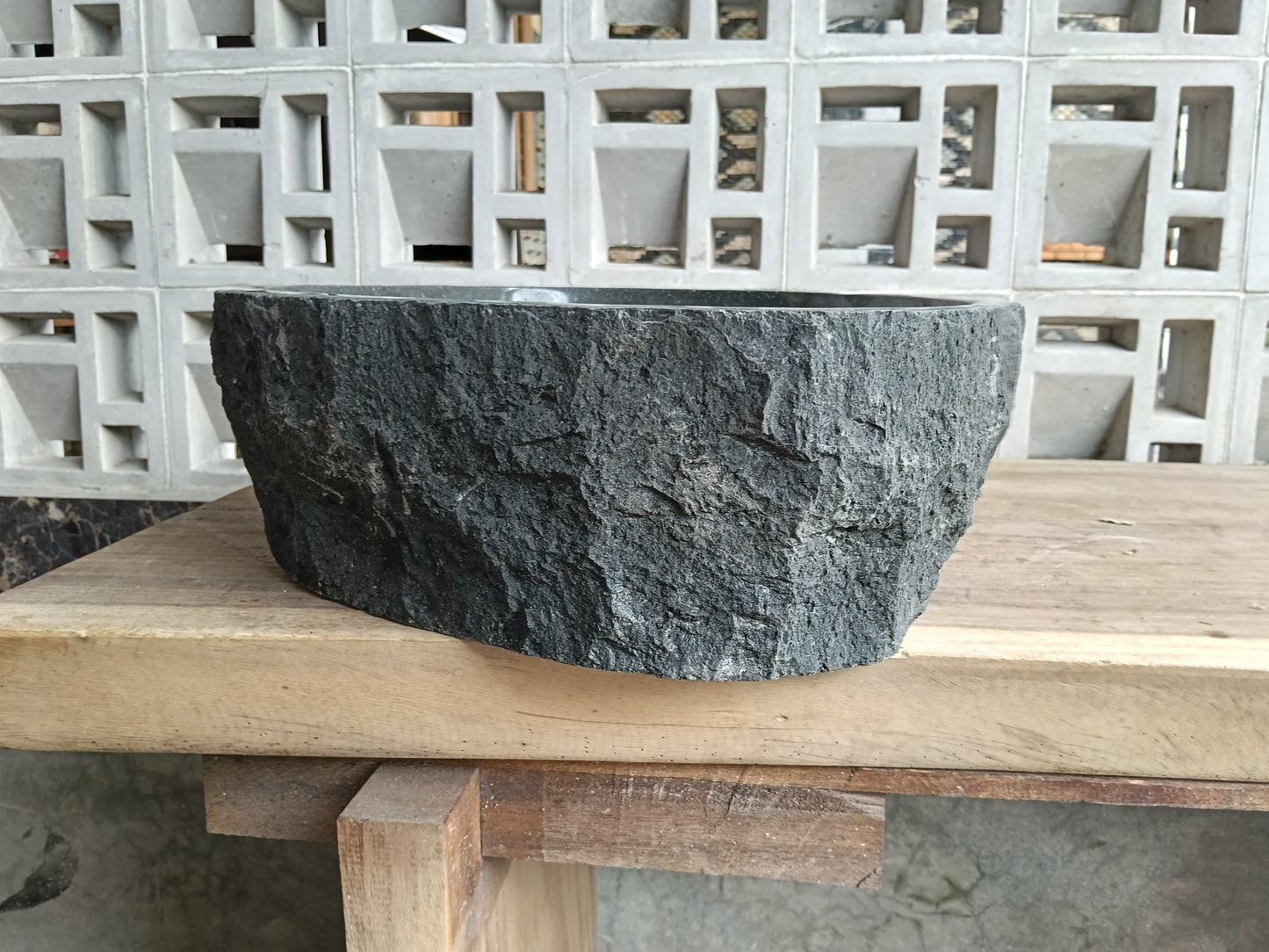 Left side of 6A37-5141 round andesite stone sink
