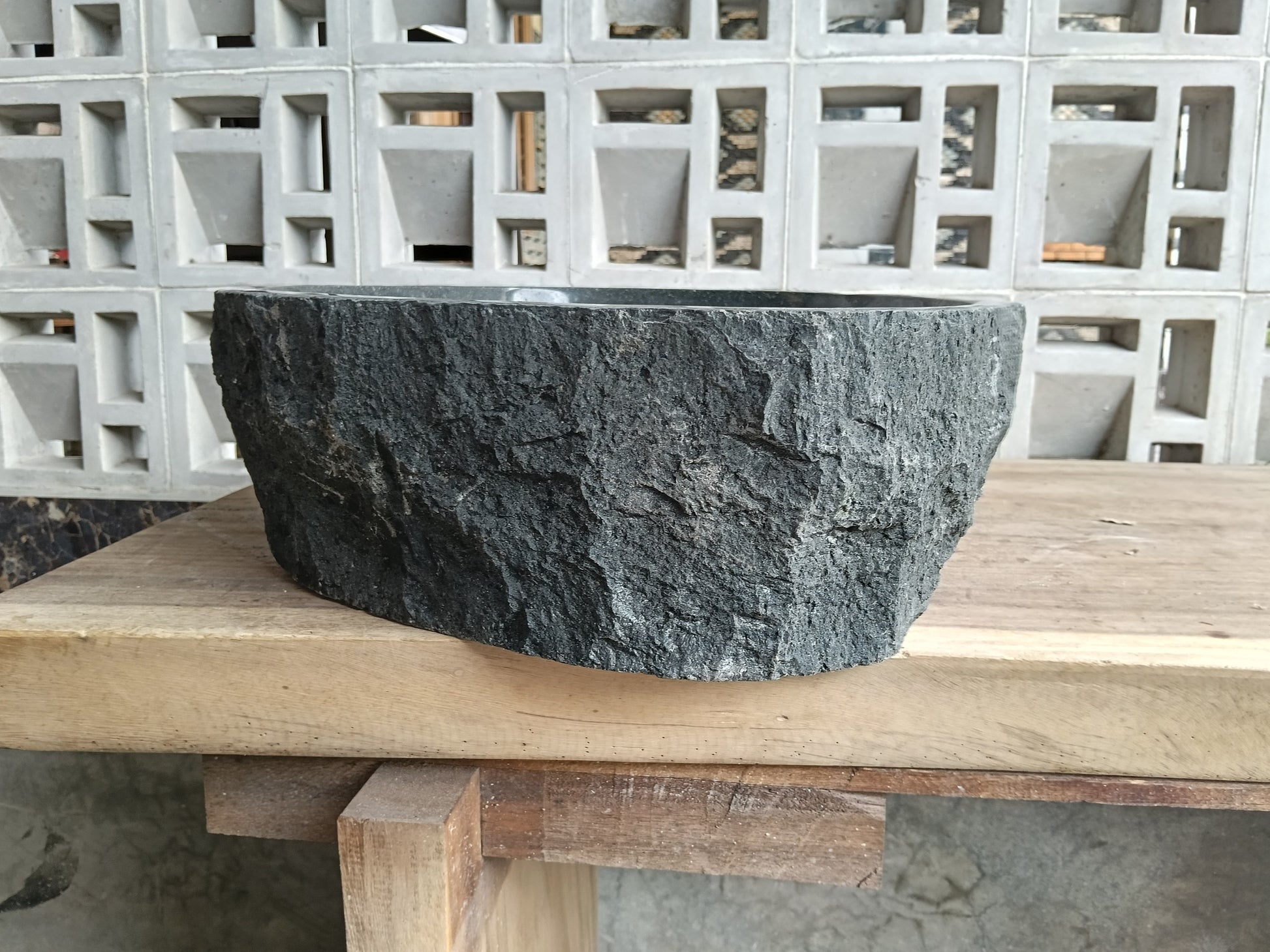 Left side of 6A37-5141 round andesite stone sink
