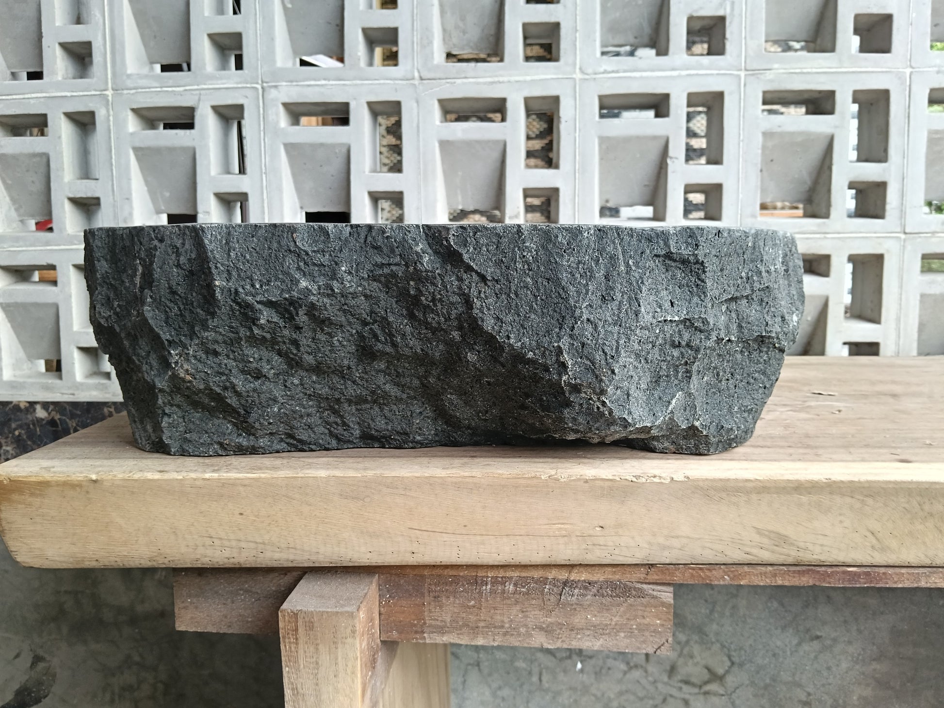 Back view of 6A37-5141 natural andesite basin — textured exterior surface
