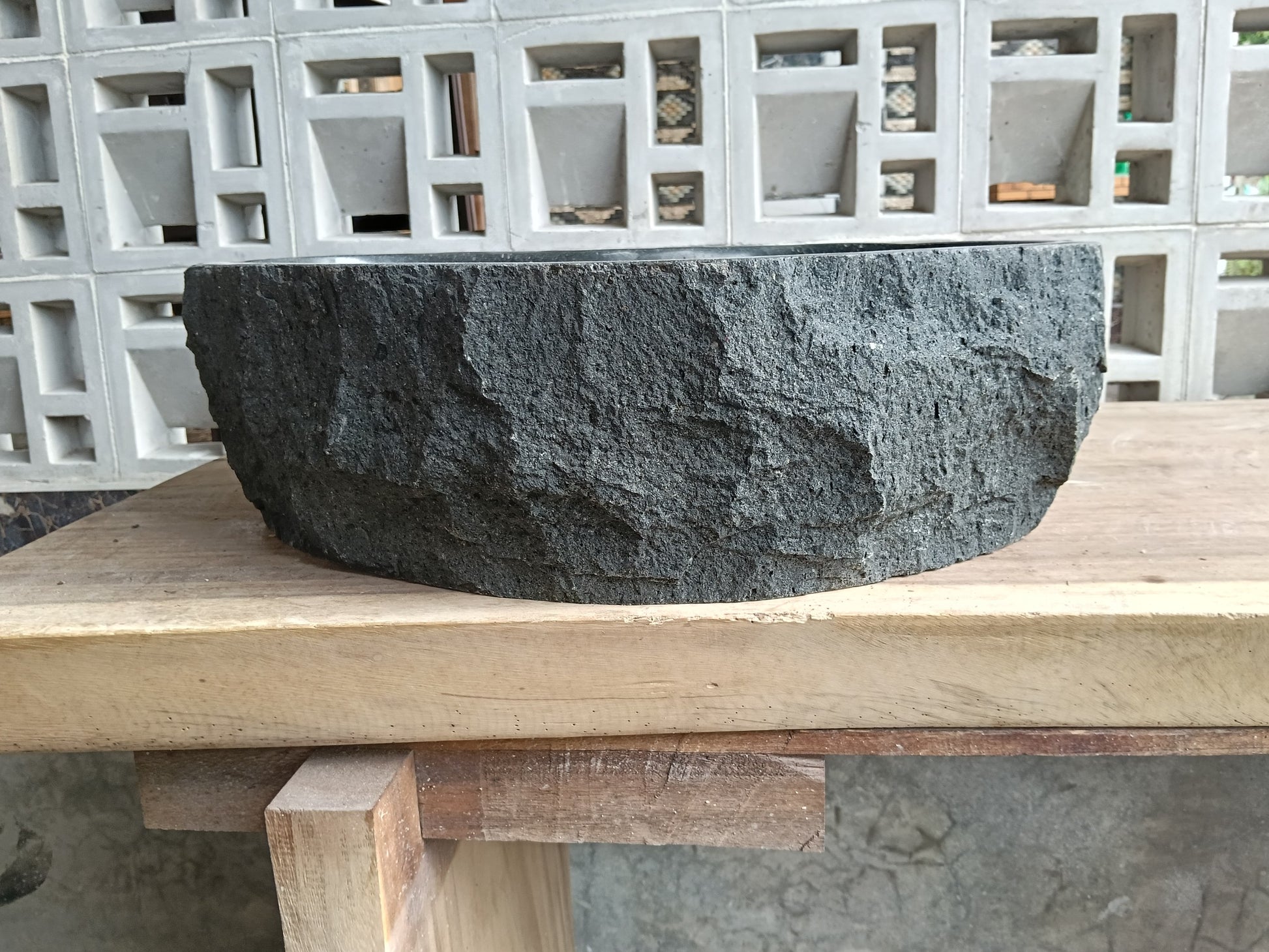Back view of 6A40-5039 natural andesite basin — textured exterior surface
