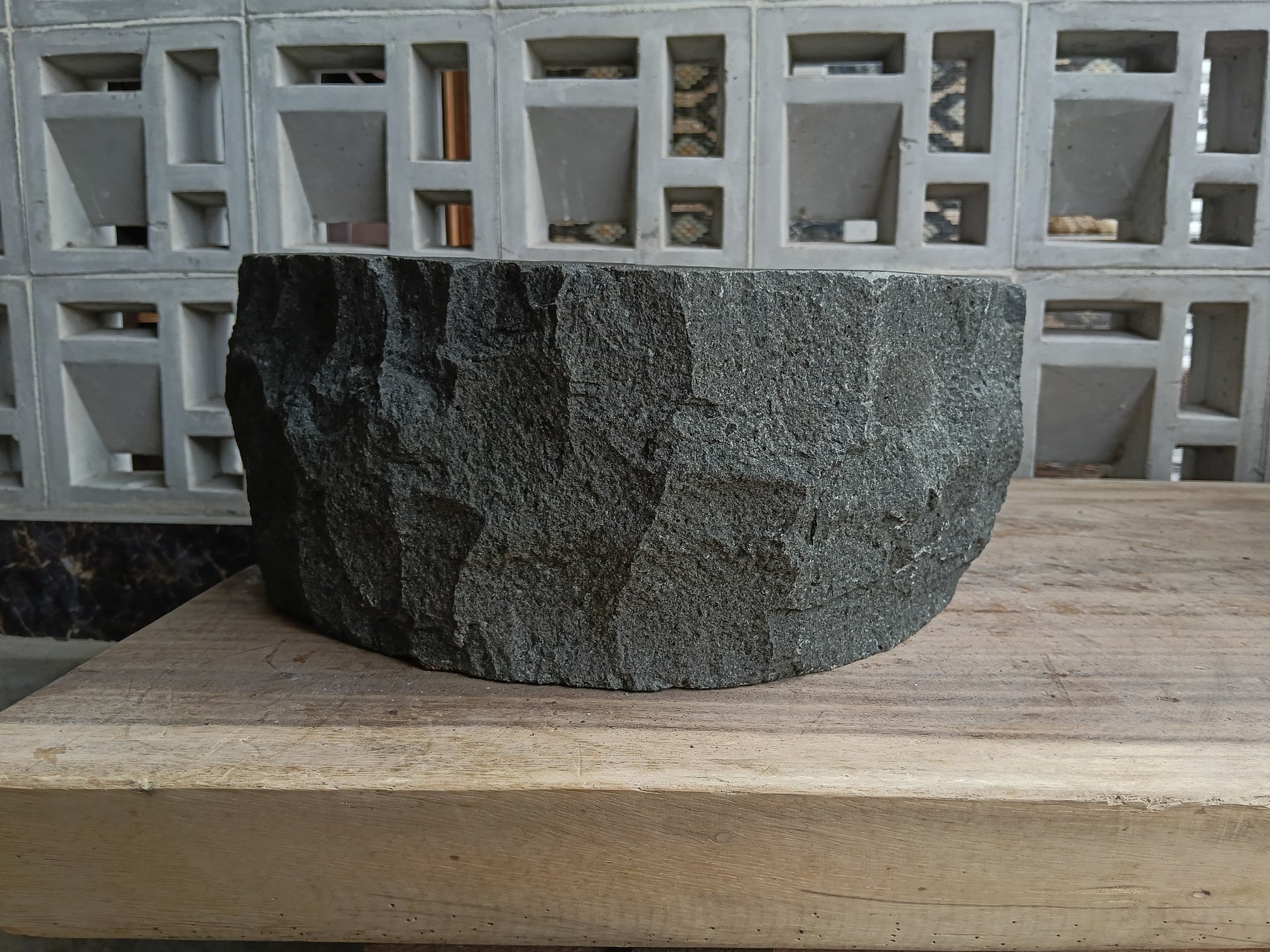 Back view of 6A20-4137 natural andesite basin — textured exterior surface
