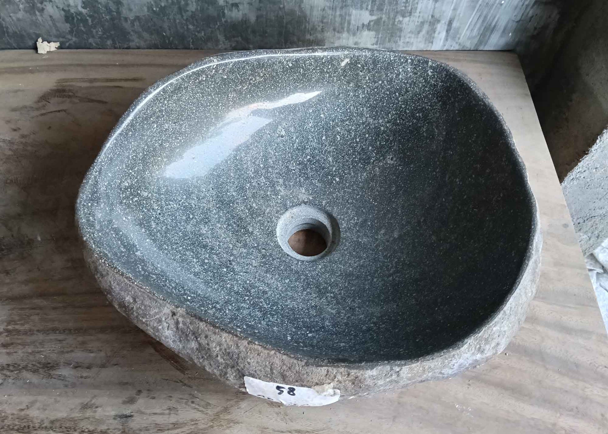 Top view of handcrafted 16×14 inch gray river stone sink with irregular interior shape
