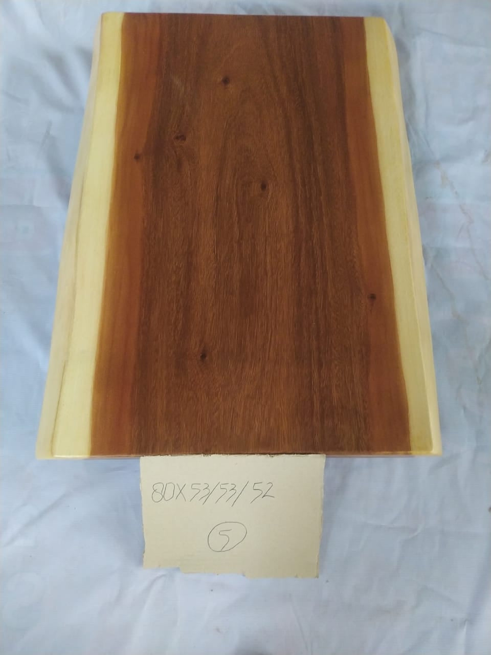Top view of suar wood slab 0005-535352 with live edge shape and warm brown natural wood grain, solid single-piece countertop.
