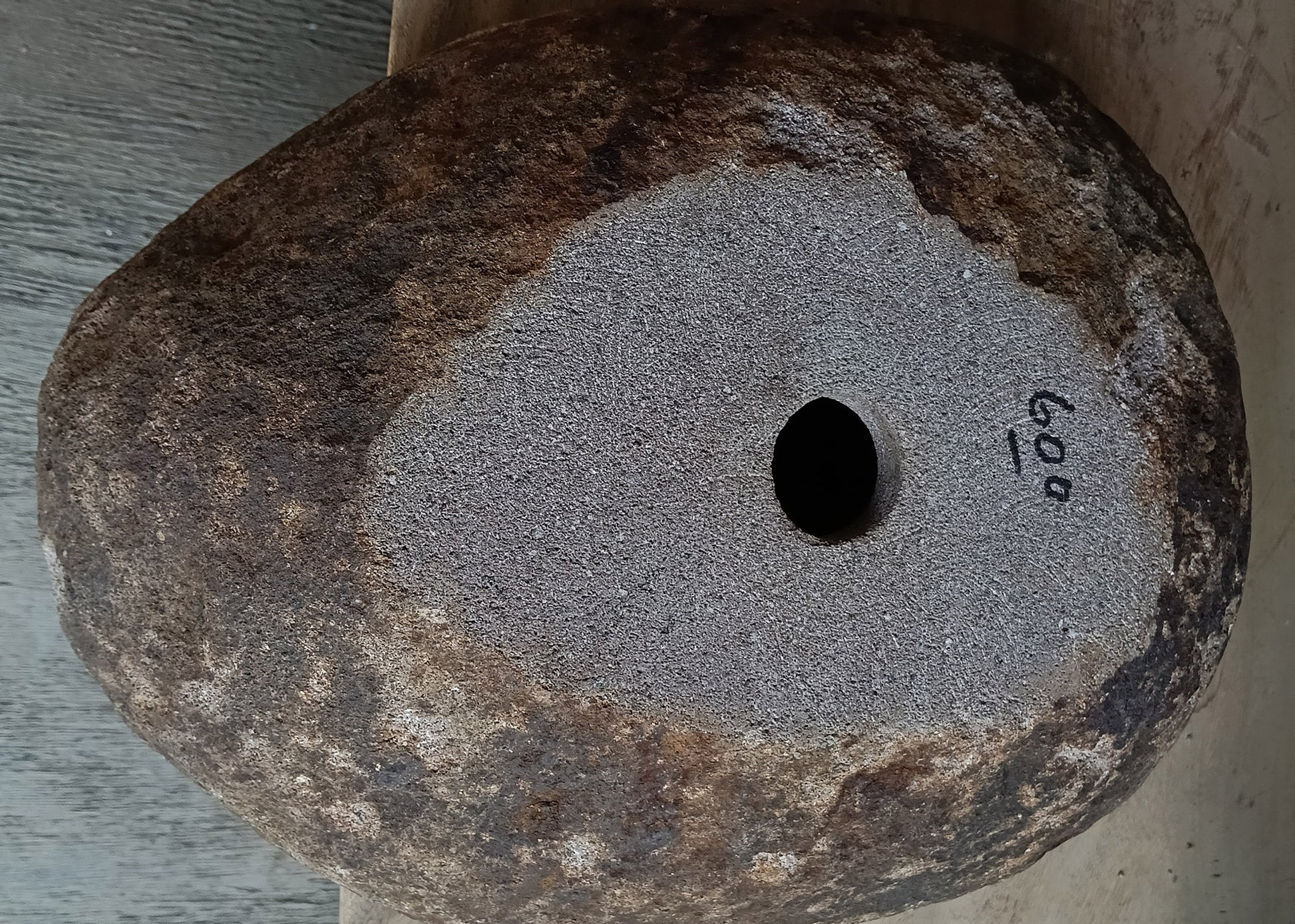 Bottom view of handcrafted dark brown oval river stone sink 6600-1824

