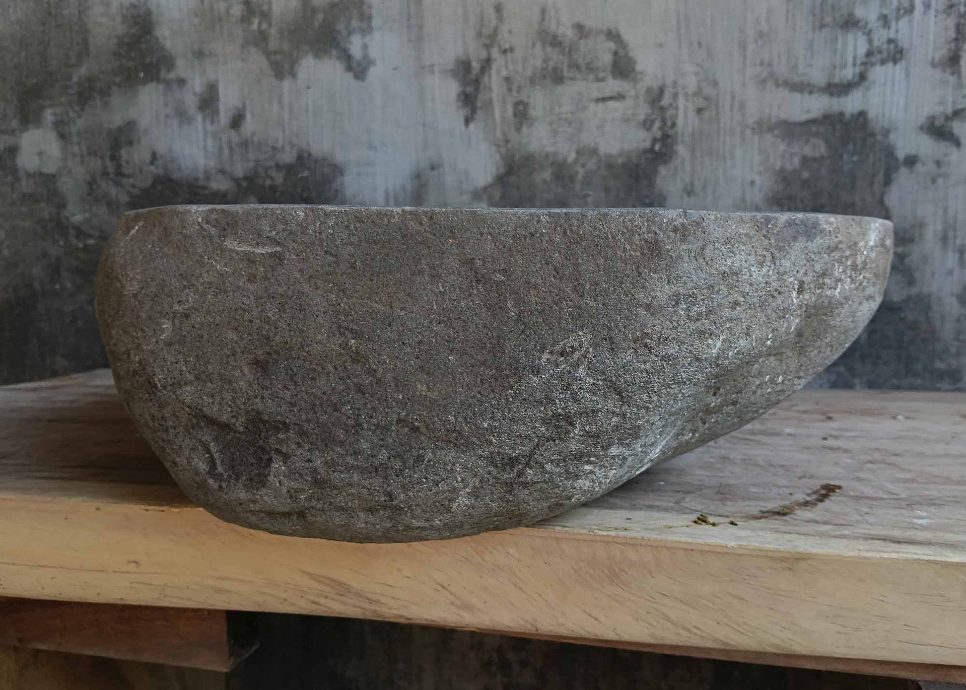 Left side view of oval dark gray river stone sink 6648-5145 with rough exterior
