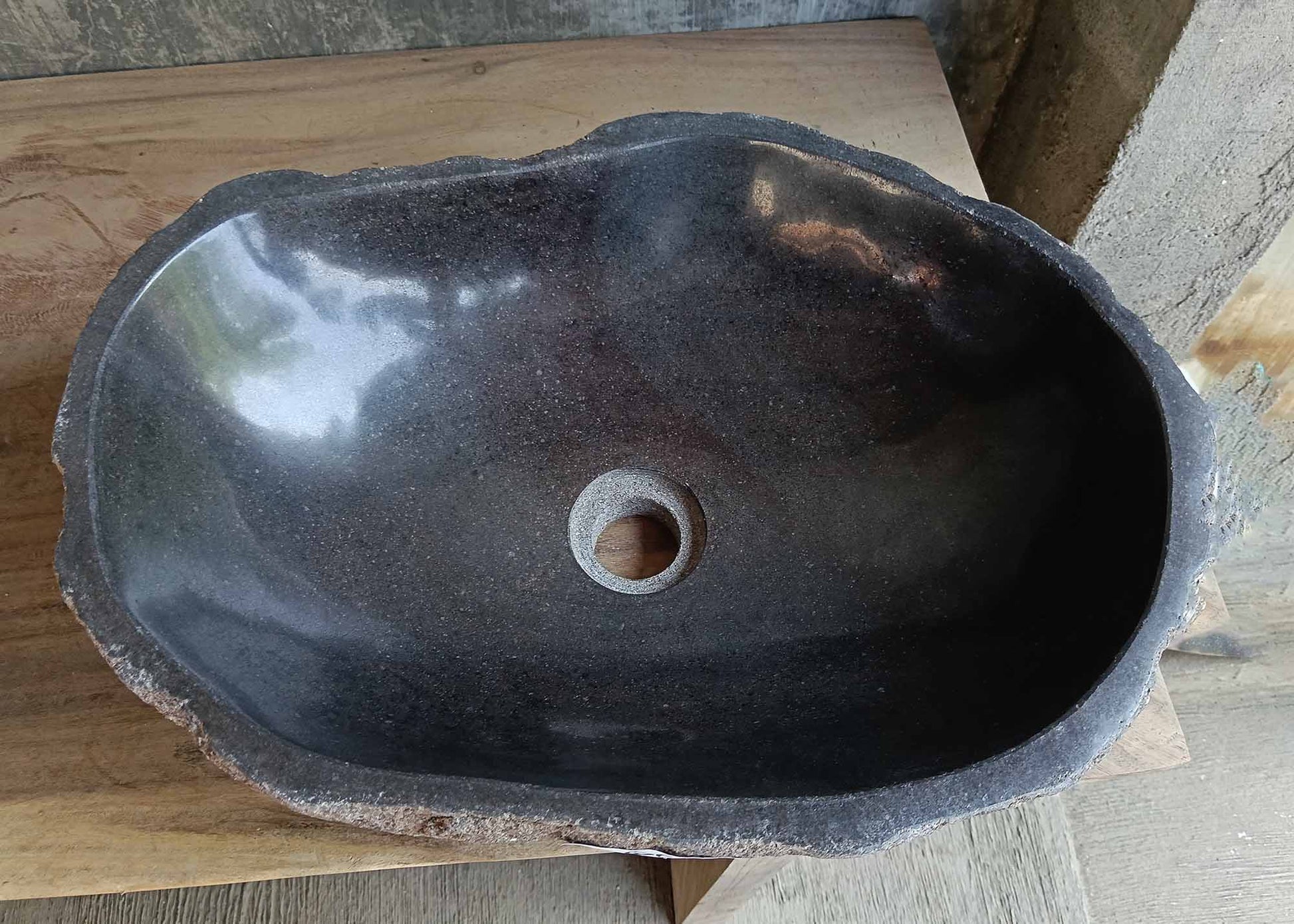 Top view of oval dark gray river stone sink 6666-4835 with polished interior
