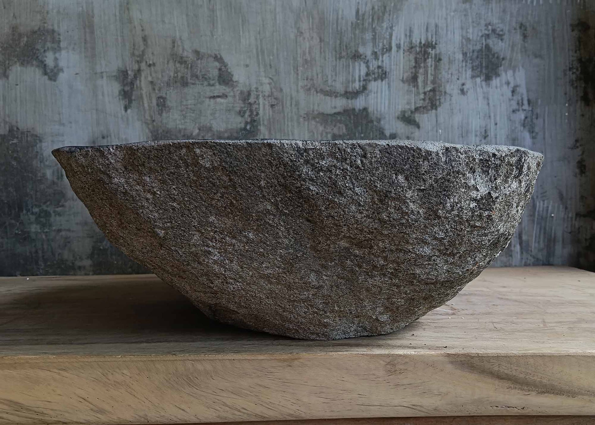 Back view of handcrafted dark gray river stone sink 6676-5343 with textured stone surface

