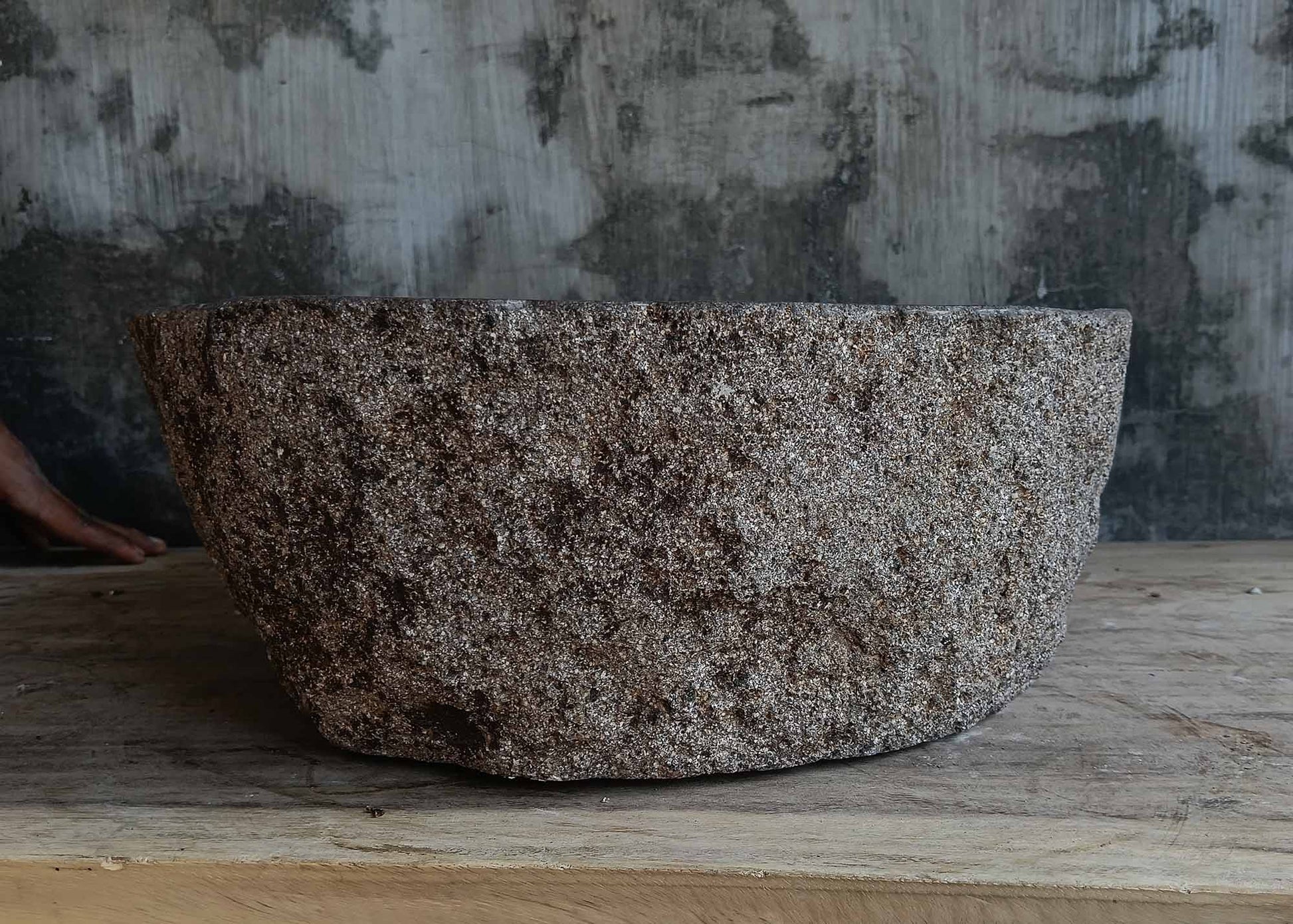 Back view of handcrafted dark gray river stone sink 6677-4335 with textured stone surface
