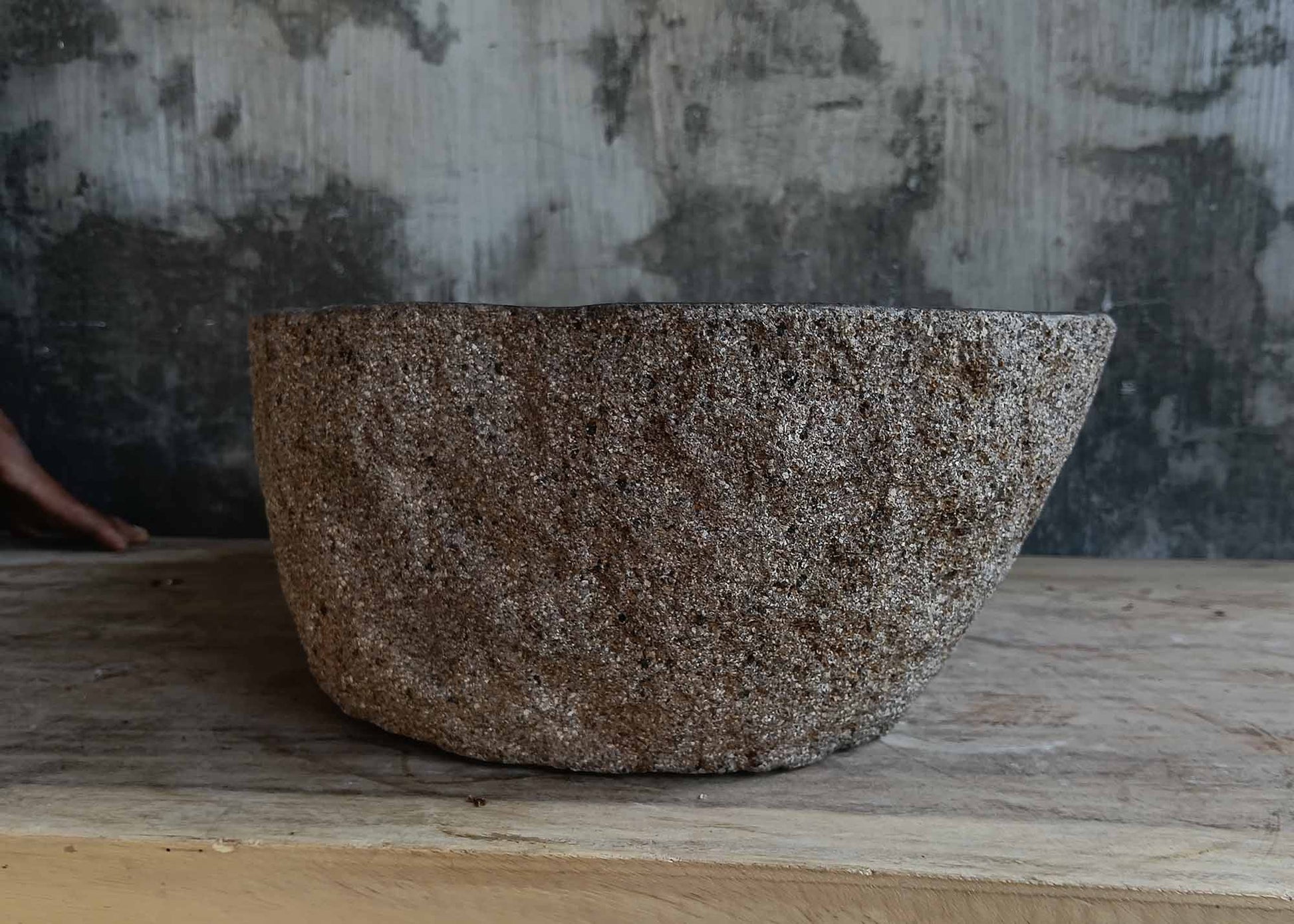 Left side view of handcrafted dark gray river stone sink 6677-4335 with organic shape
