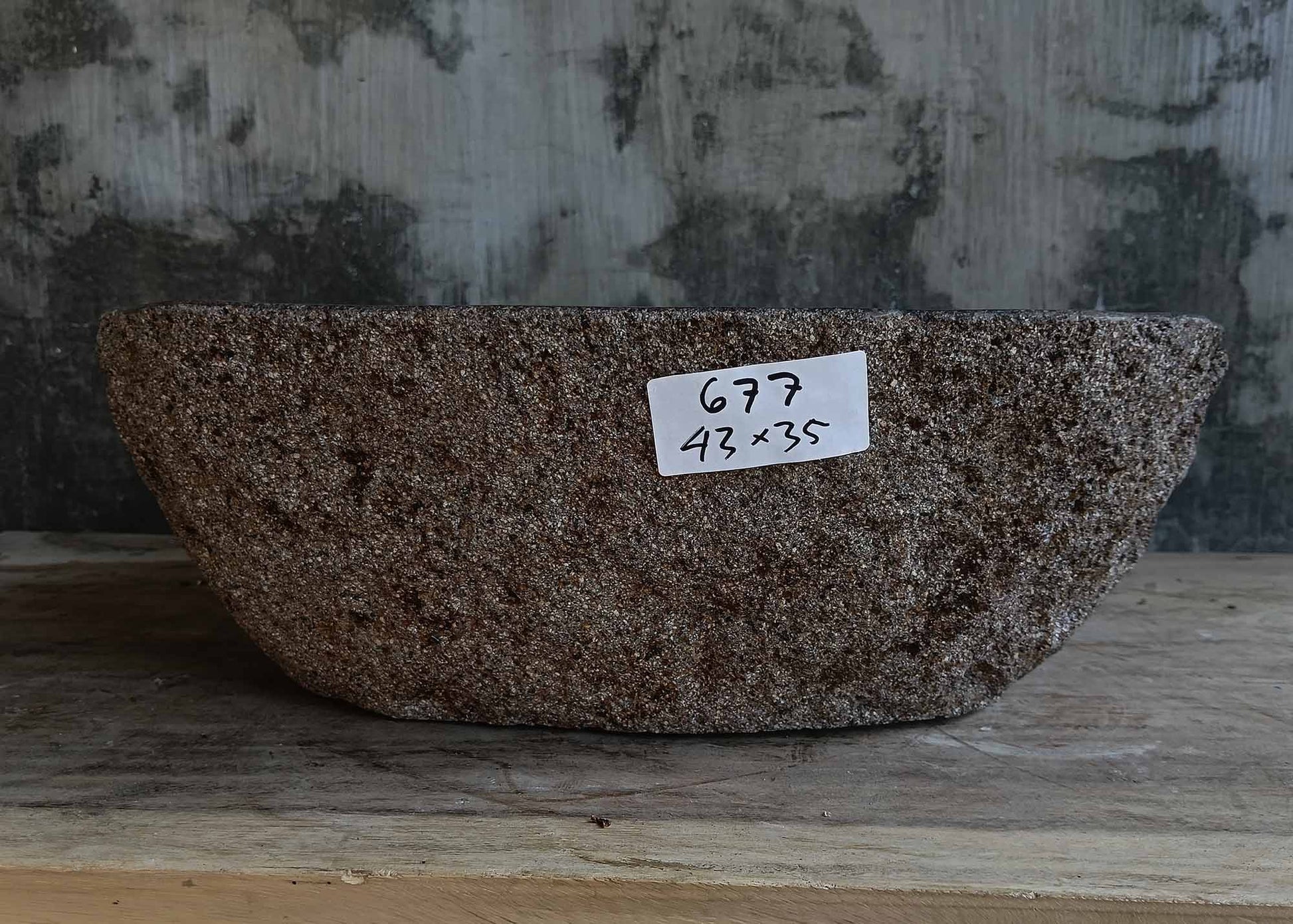 Front view of handcrafted dark gray river stone sink 6677-4335 with natural rough exterior
