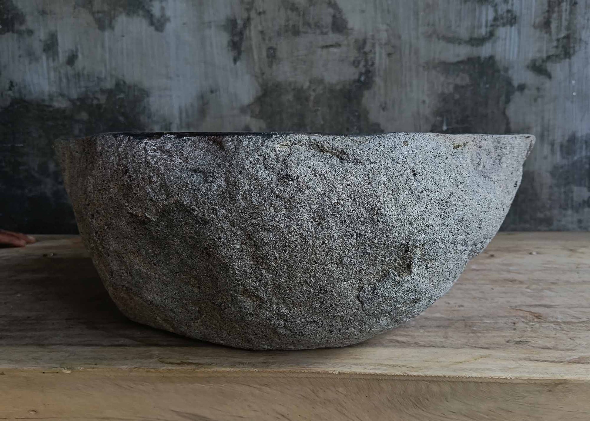 Back view of handcrafted dark gray river stone sink 6678-4337 with textured stone surface
