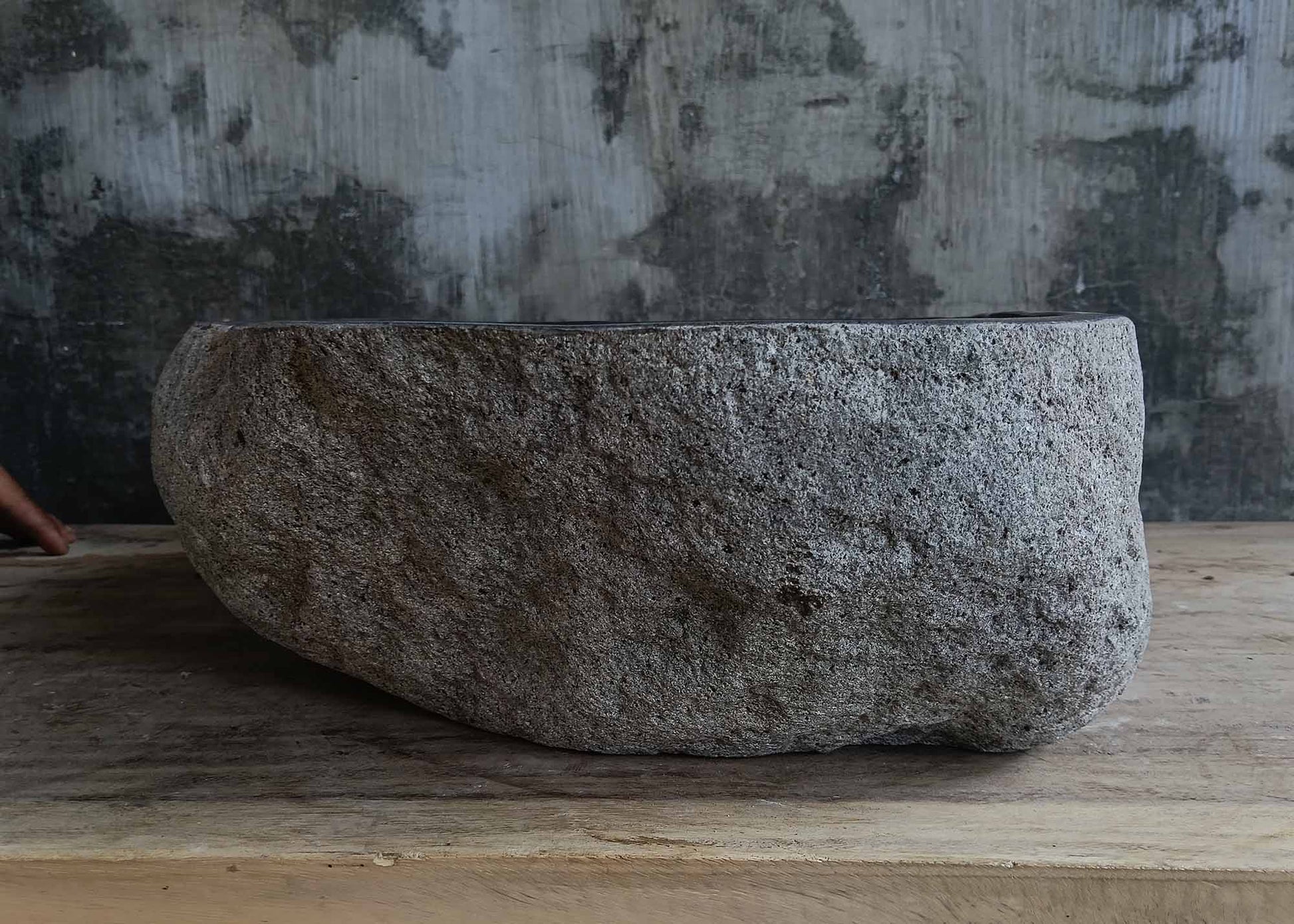 Left side view of handcrafted dark gray river stone sink 6678-4337 with organic shape
