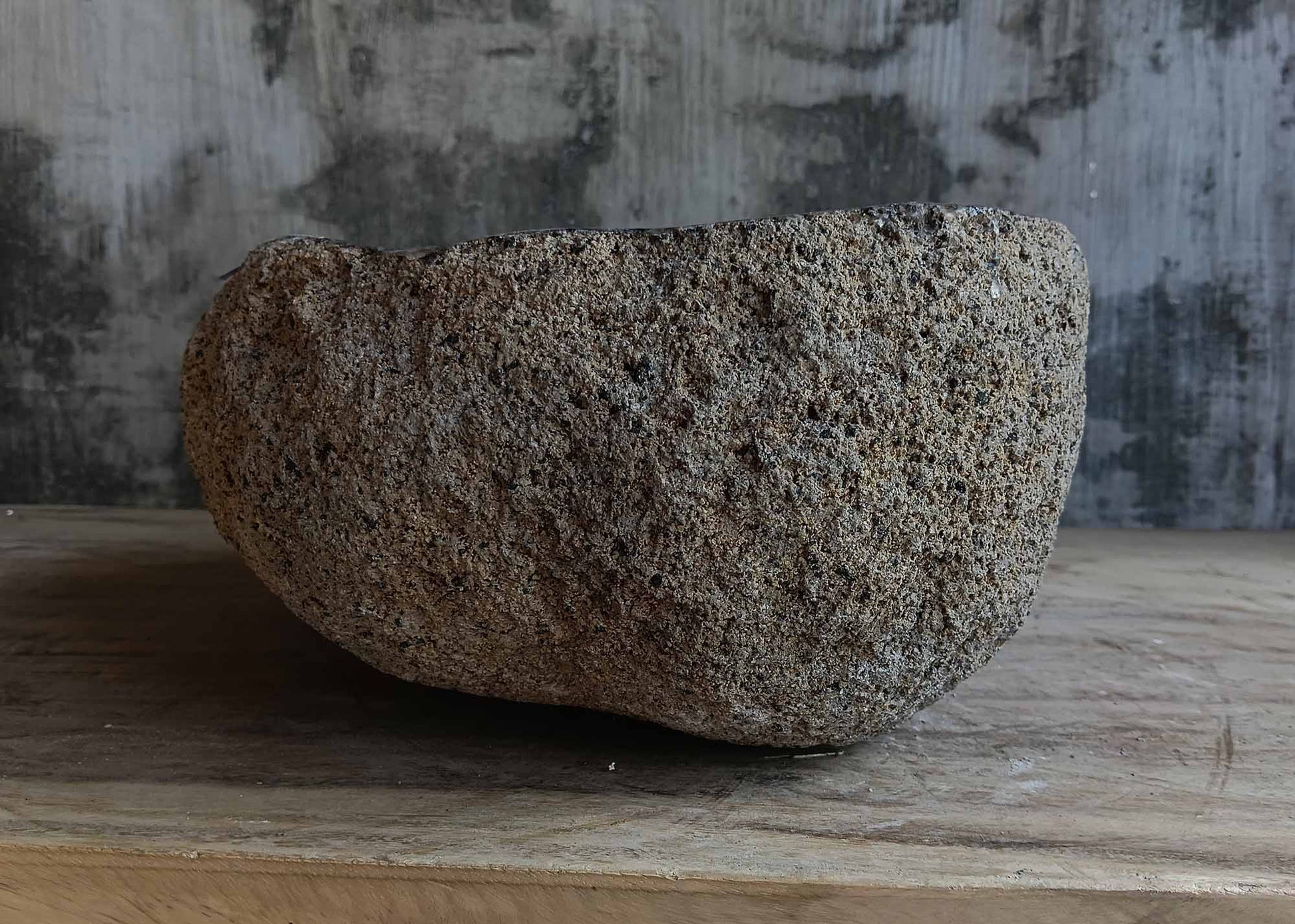 Left side view of handcrafted light brown river stone sink 6680-3731 with organic shape
