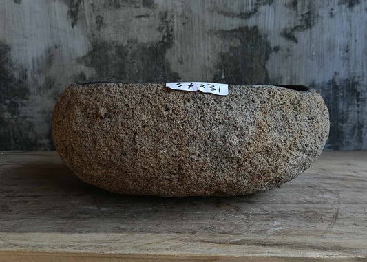 Front view of handcrafted light brown river stone sink 6680-3731 with natural rough exterior
