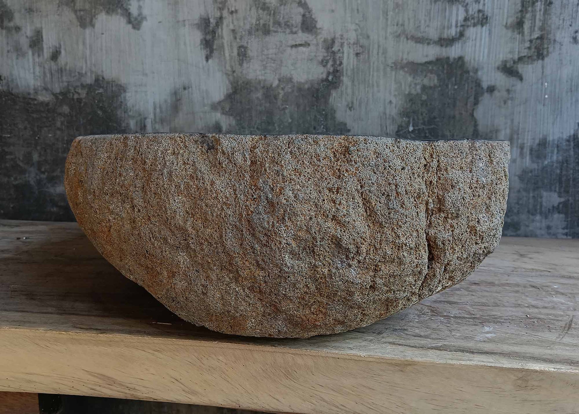 Left side view of handcrafted brown-gray river stone sink 6681-5837 with organic shape
