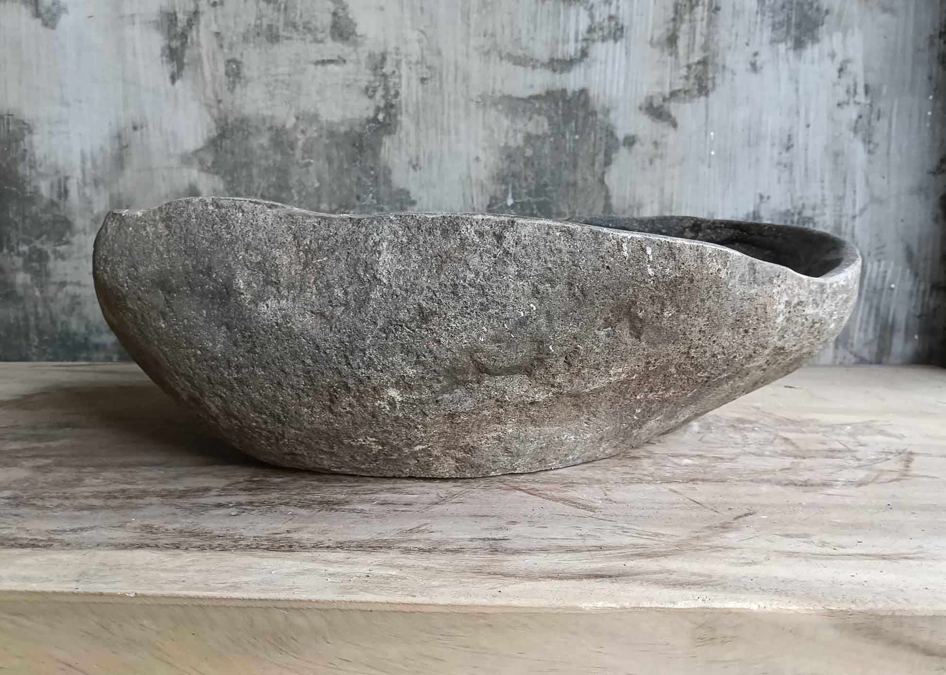 Front side view of handcrafted 19×14 inch stone sink with mixed color bands and textured surface
