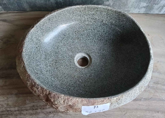 Top view of handcrafted 18×15 inch river stone sink showing interior shape and color

