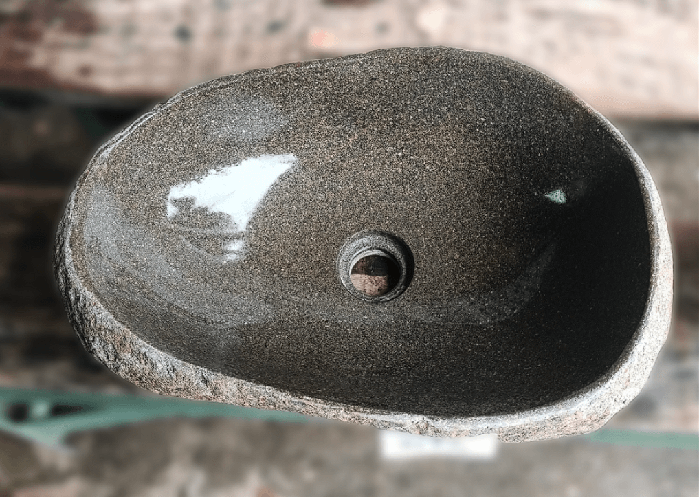 Top view of handcrafted brown 18×13 inch river stone sink in oval shape
