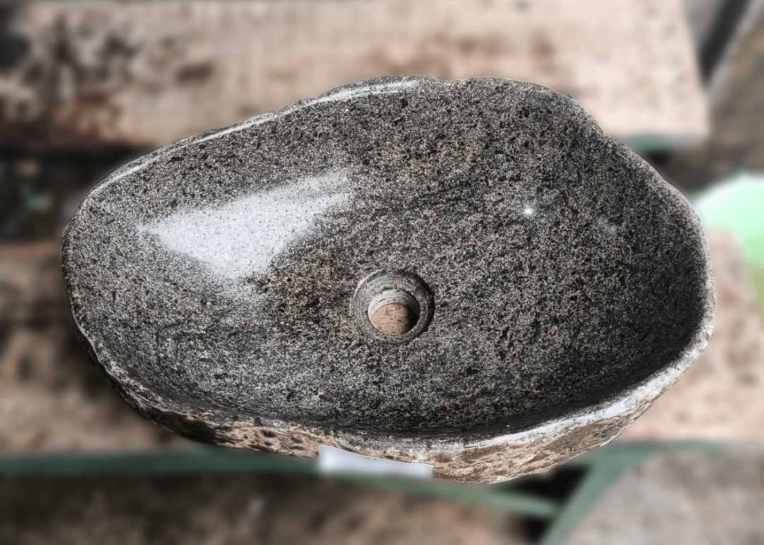 Top view of handcrafted grey 18×13 inch river stone sink in oval-triangle form

