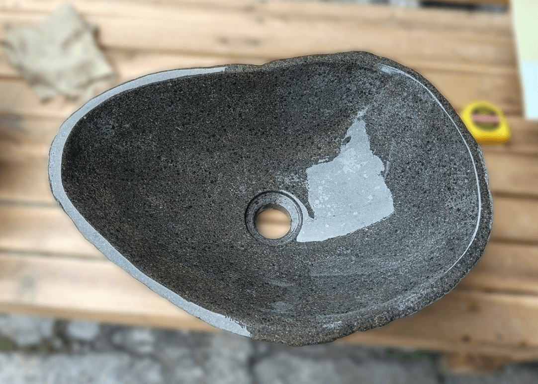 Top view of handcrafted grey 17×12 inch river stone sink in oval shape

