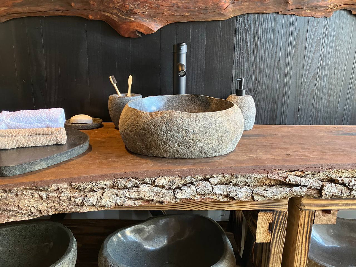 Rounded oval river stone vessel sink RSC-089 with a dark basin and natural stone exterior
