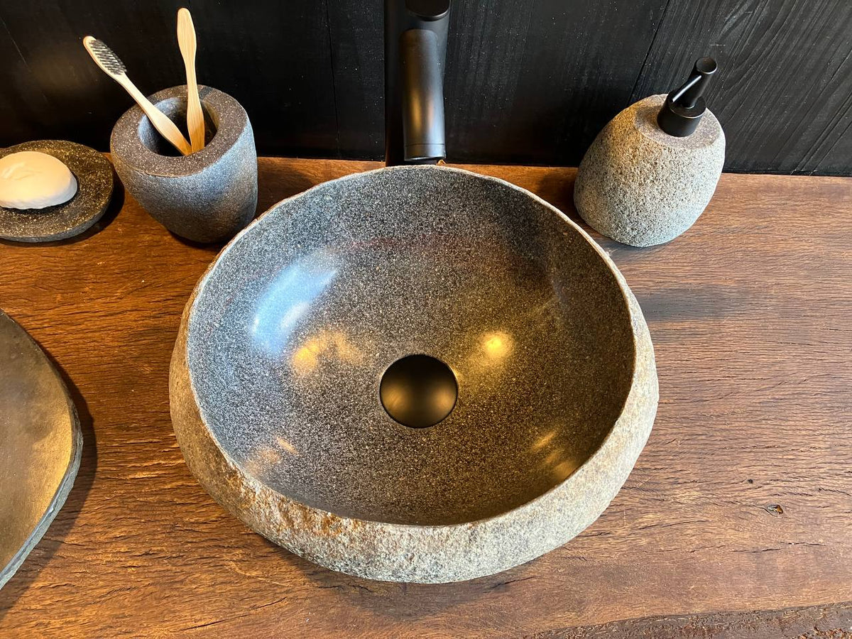 Top view of river stone sink RSC-089 showing its even oval outline and dark interior basin