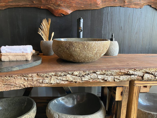 Side view of oval river stone vessel sink RSC-093 with a naturally textured gray-brown exterior